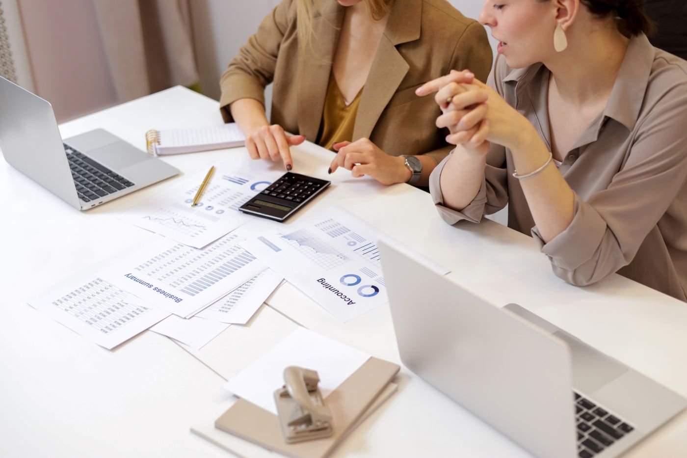 Financial documents being discussed at a desk