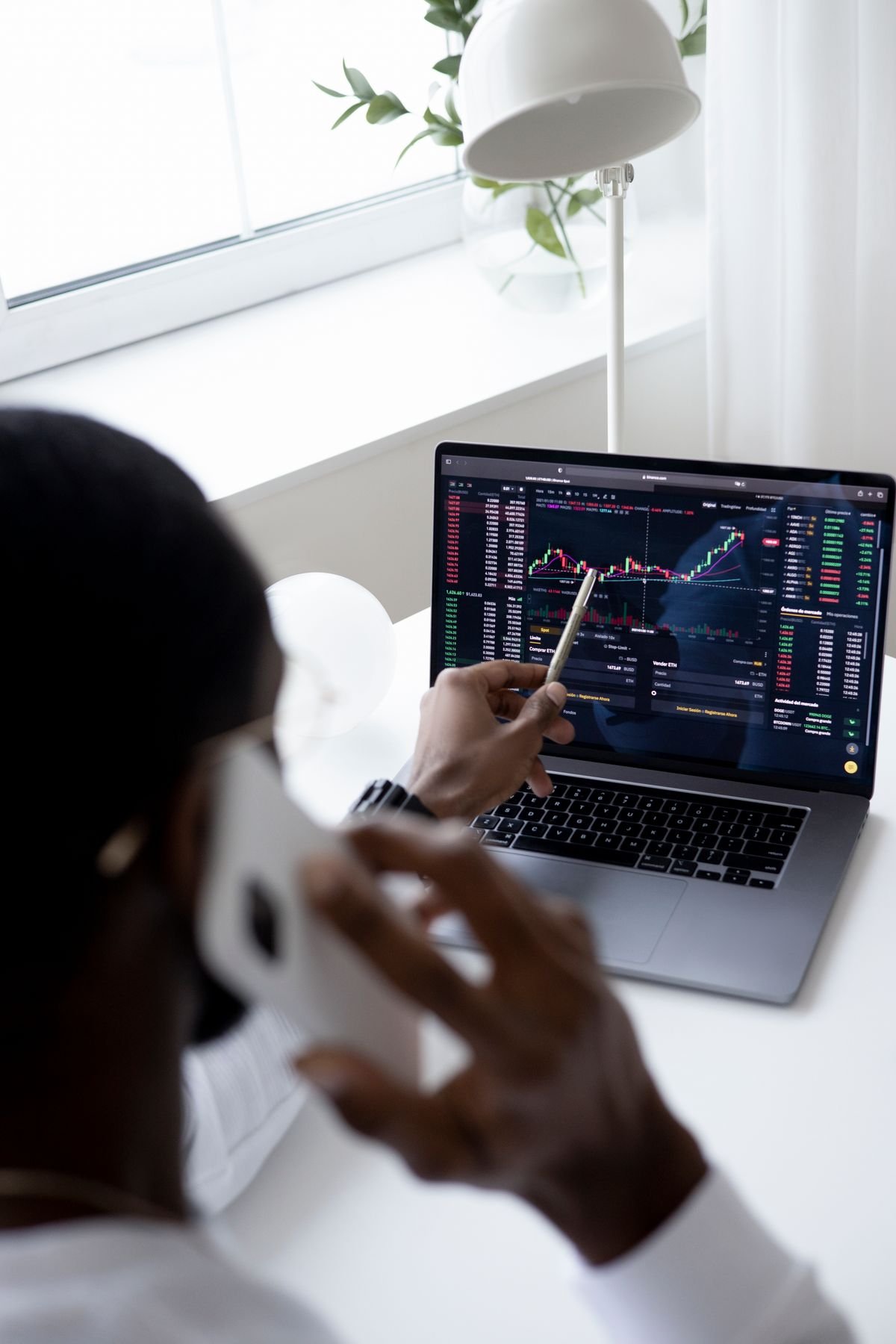 A financial market chart being reviewed on a laptop