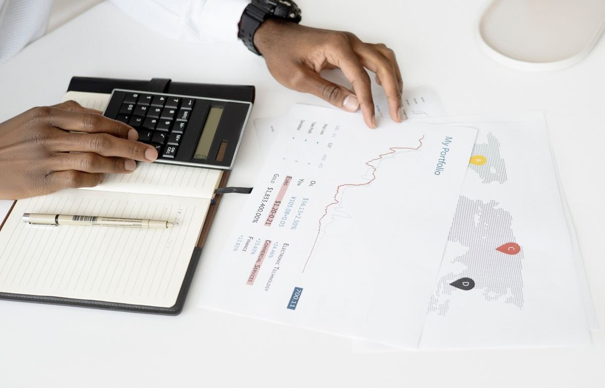 Financial documents and a calculator for learning about portfolio analysis